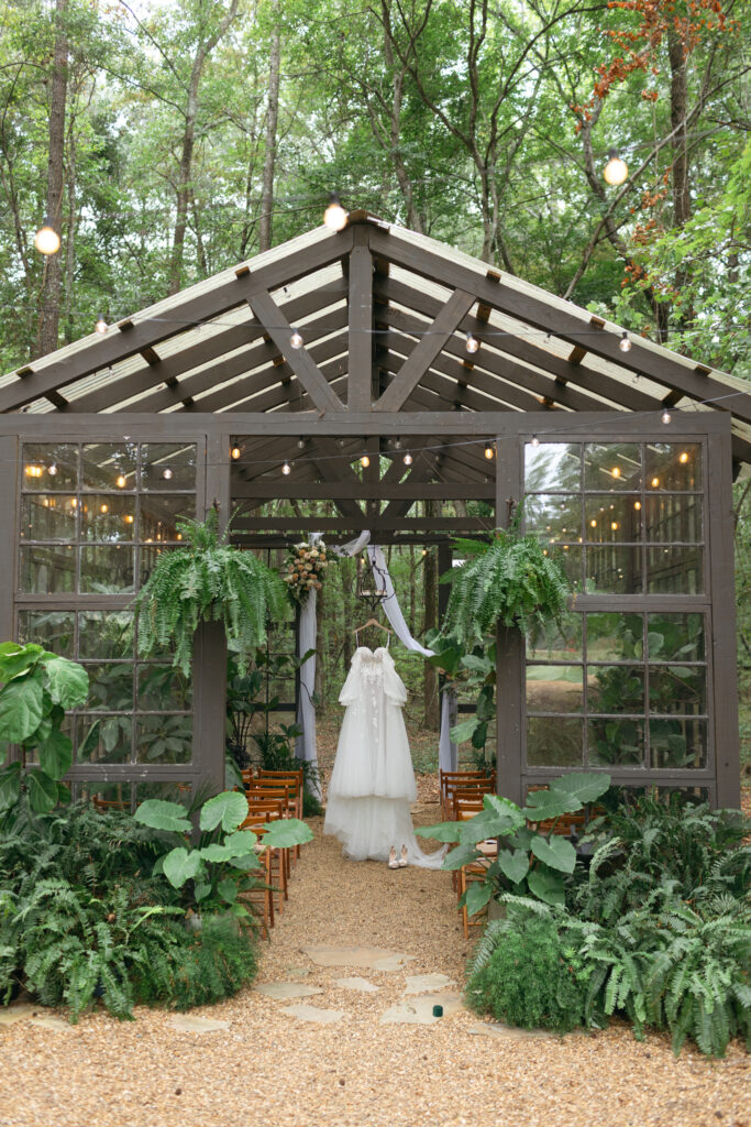 Wedding Dress hanging in a glass venue